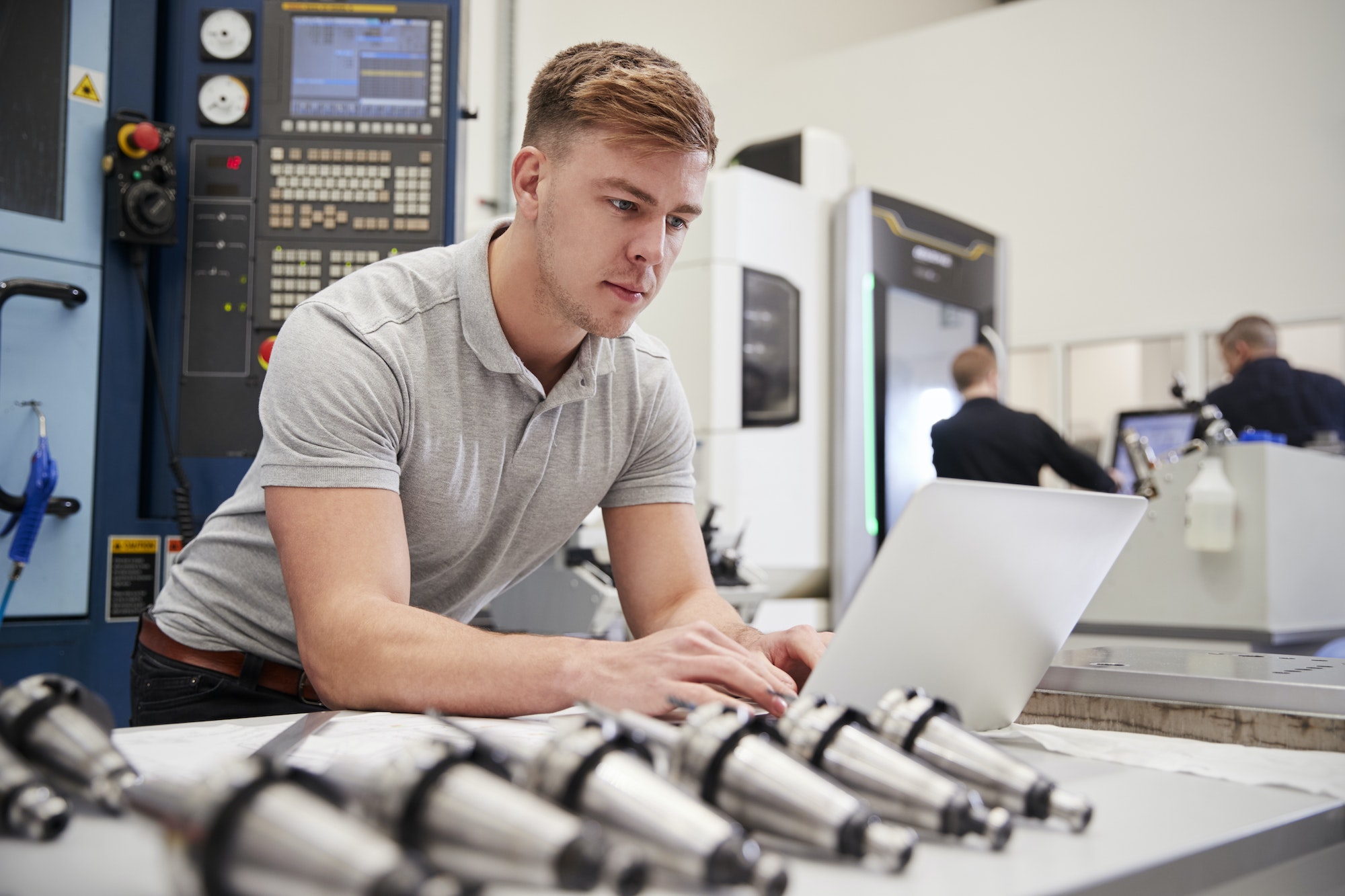 Male Engineer Using CAD Programming Software On Laptop
